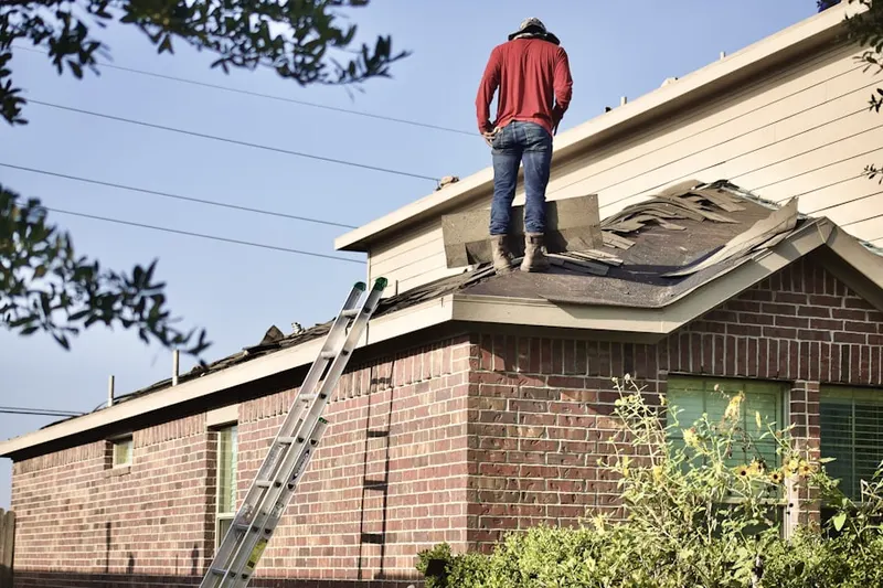 Professional roofer working on a residential roof in White Rock Estates